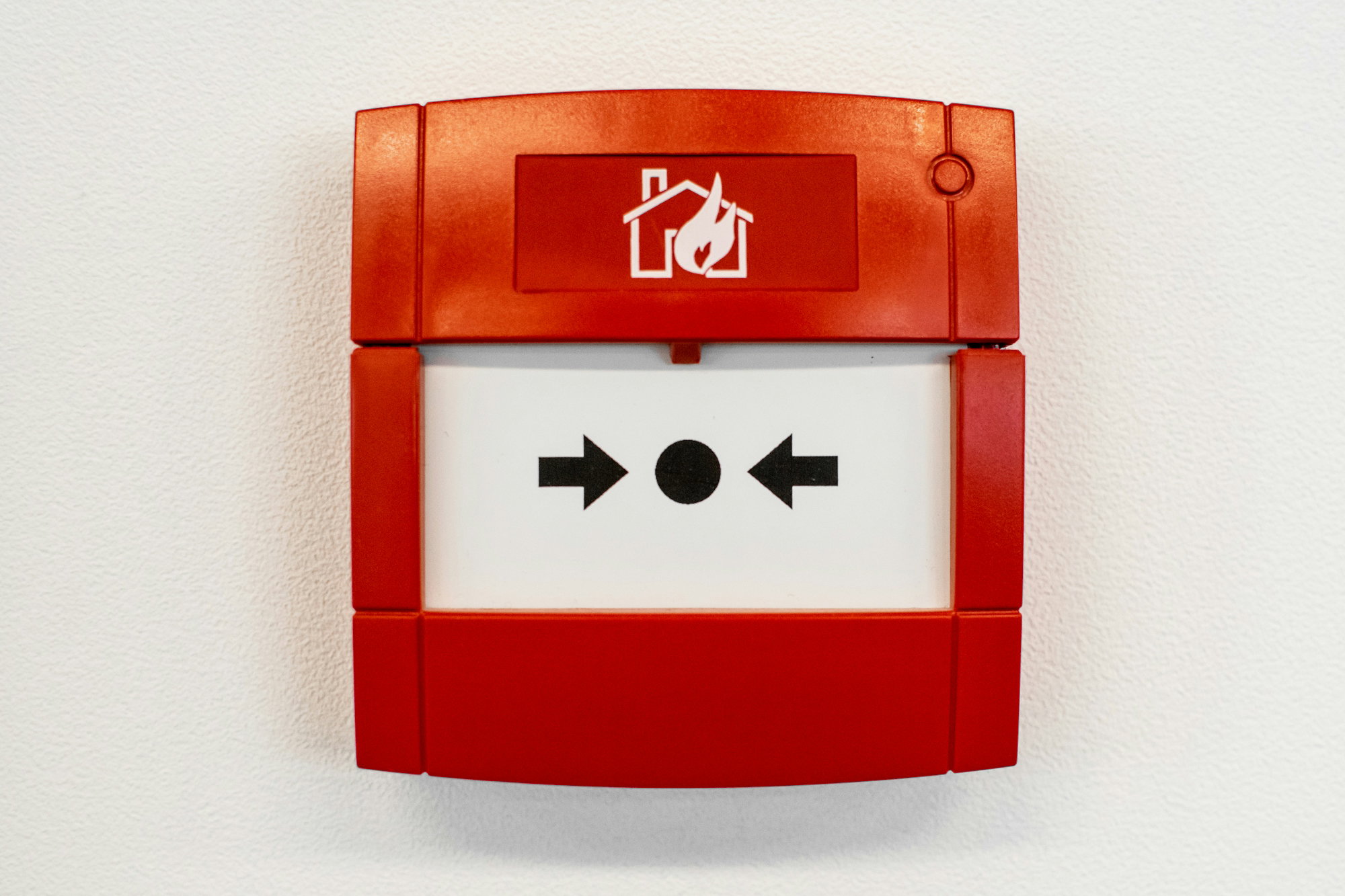 a-red-and-white-sign-on-a-white-wall.jpg a red and white sign on a white wall
